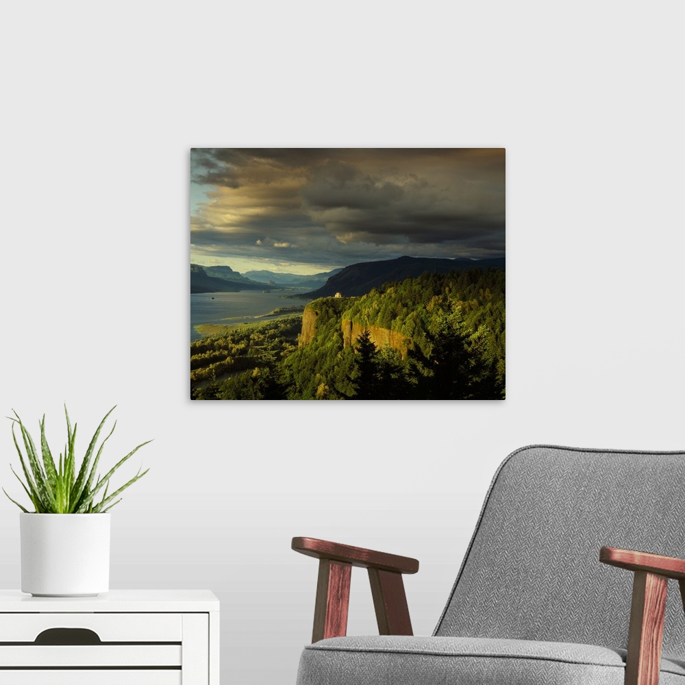 A modern room featuring Photograph of the Columbia River lined with hills and the Vista House in the distance at golden h...