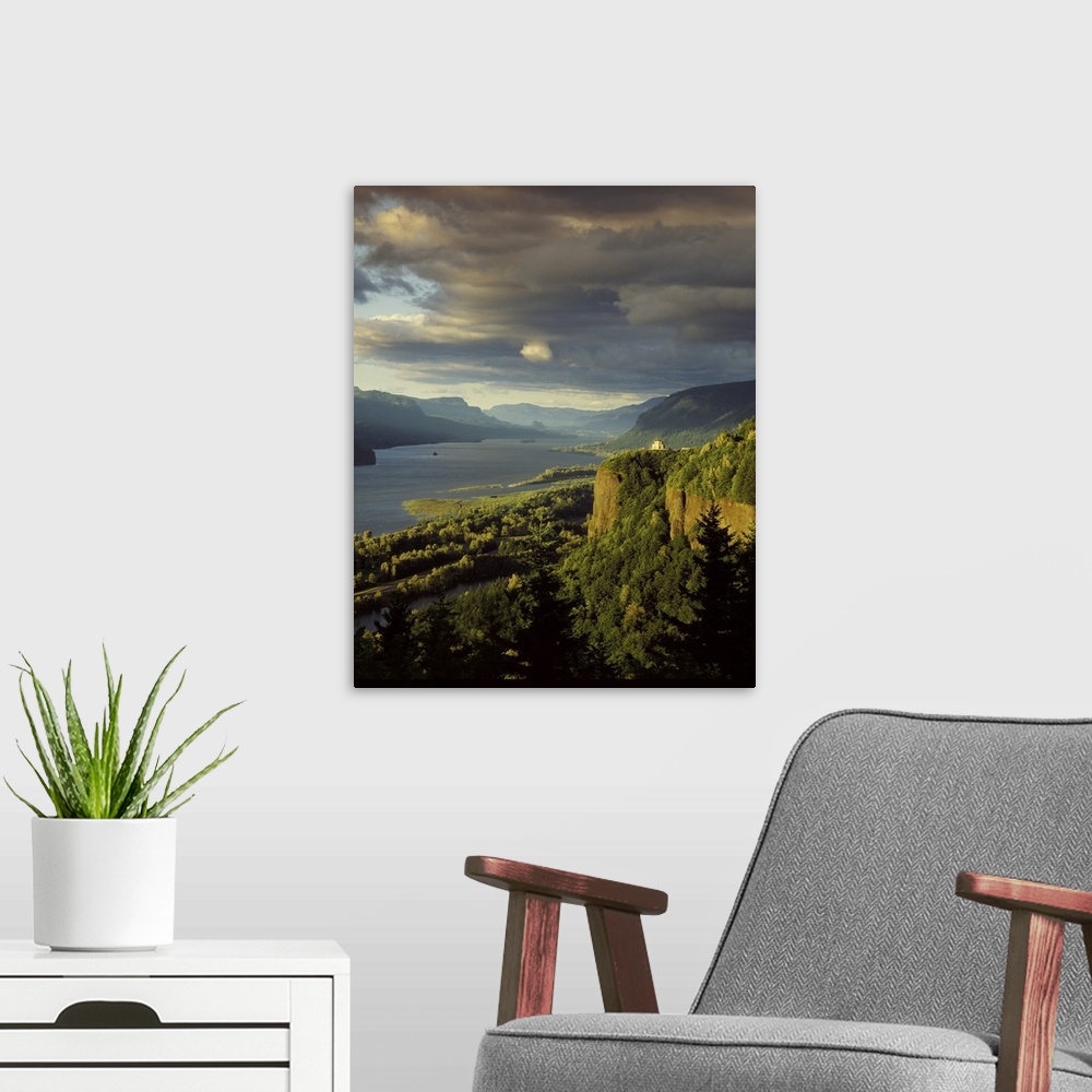 A modern room featuring Photograph of the Columbia River lined with hills and the Vista House in the distance at golden h...