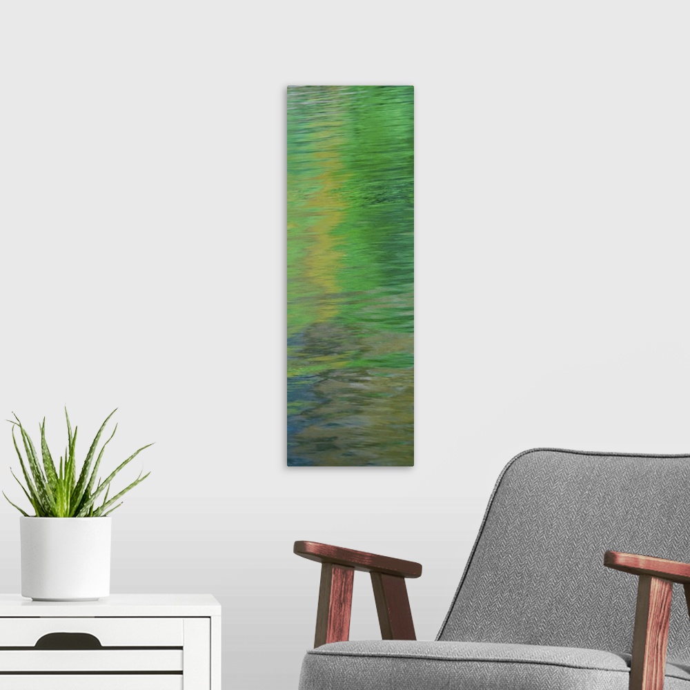 A modern room featuring Abstract image of green reflections in the water.