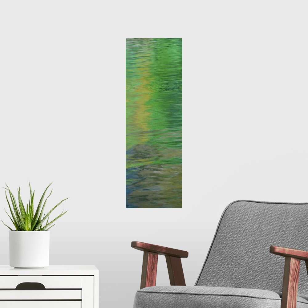 A modern room featuring Abstract image of green reflections in the water.