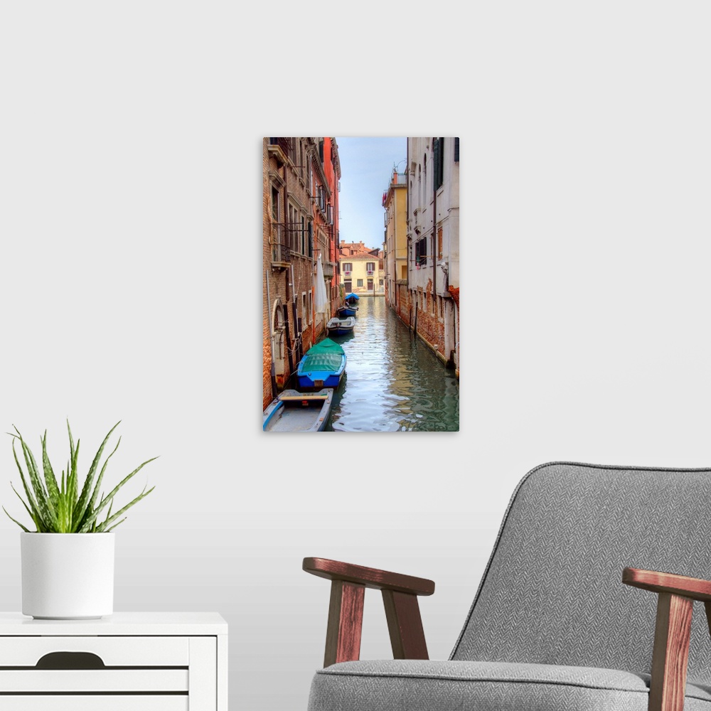 A modern room featuring HDR photograph of a canal flowing through the alleys of Venice, Italy, with small boats floating ...
