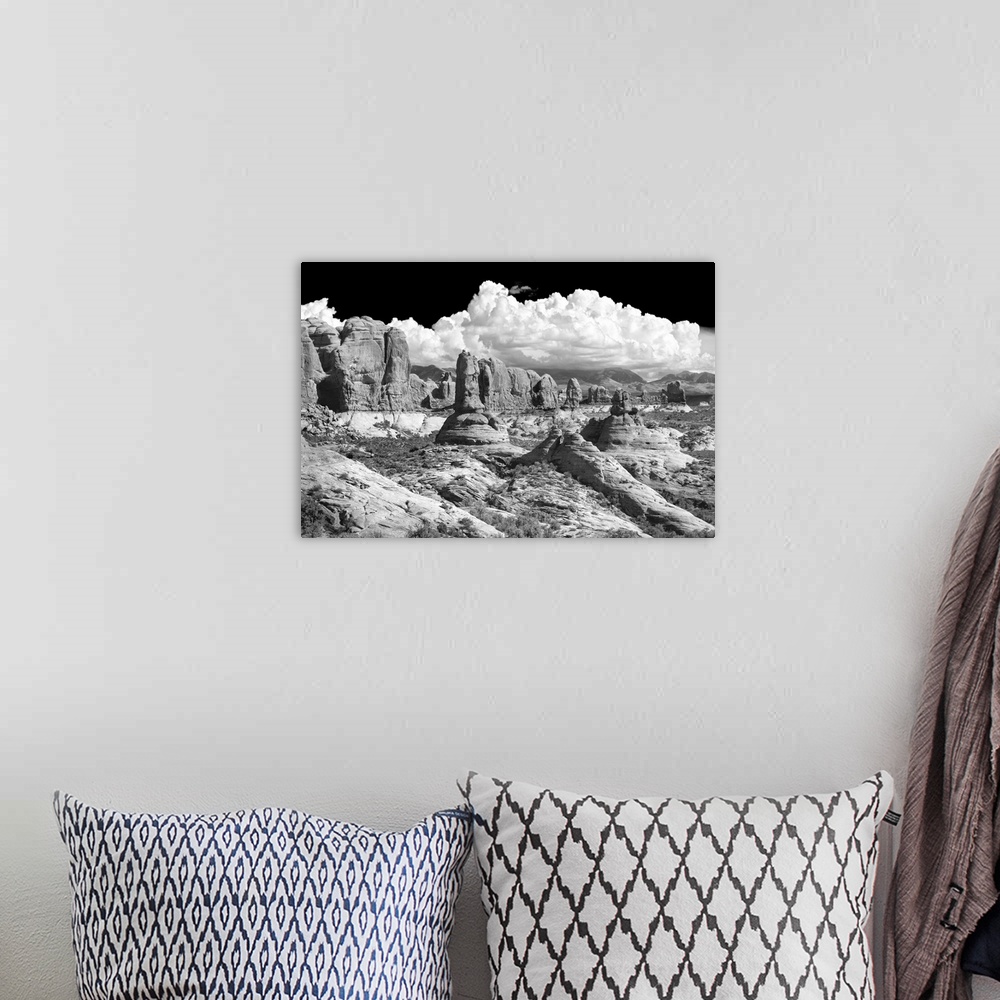 A bohemian room featuring Black and white photograph of sandstone rock formations in the desert.