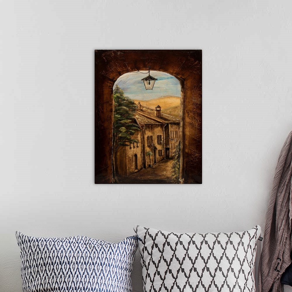 A bohemian room featuring Contemporary painting of an Italian village seen through a window.