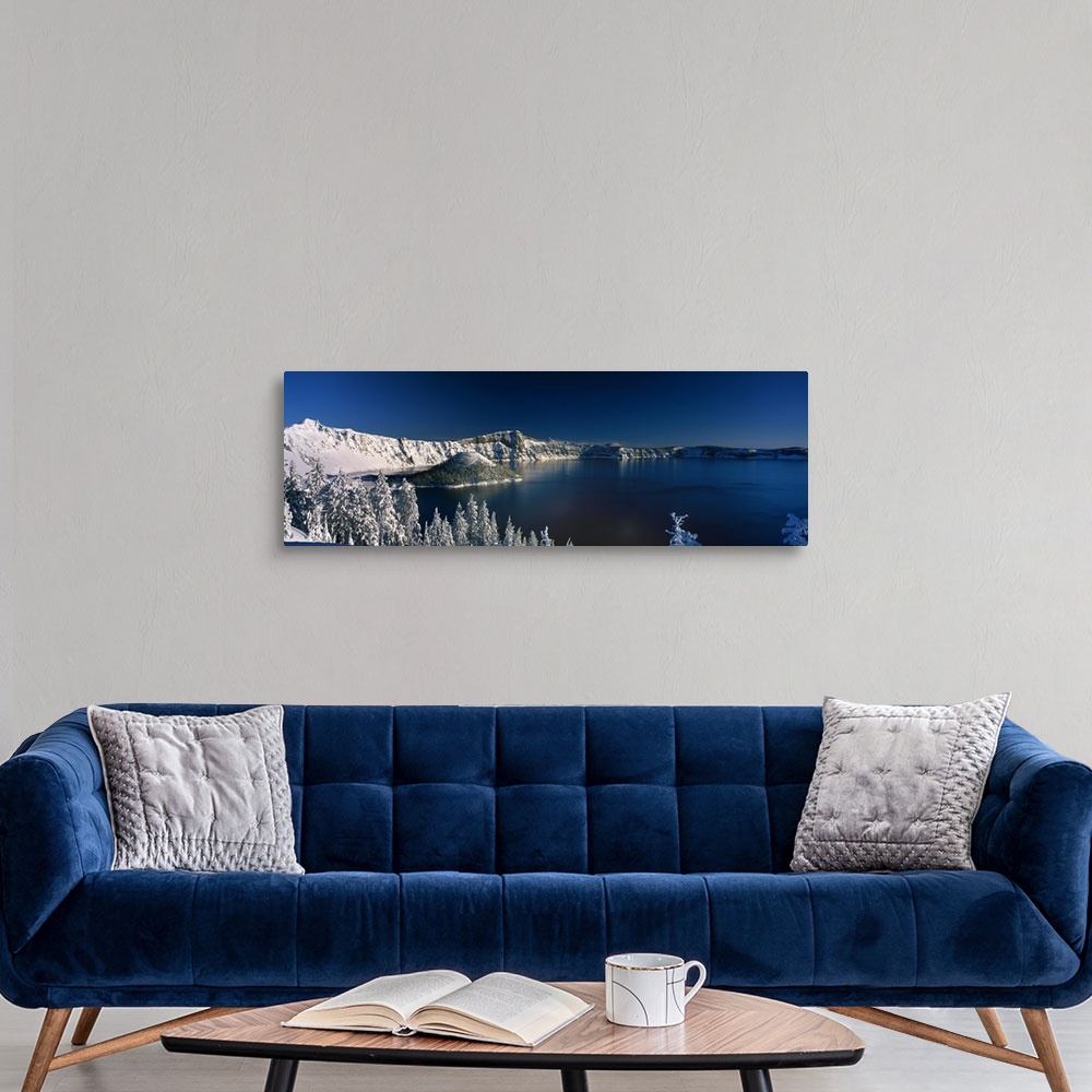 A modern room featuring Panoramic photograph of Crater Lake surrounded by snow covered mountains in Crater Lake National ...
