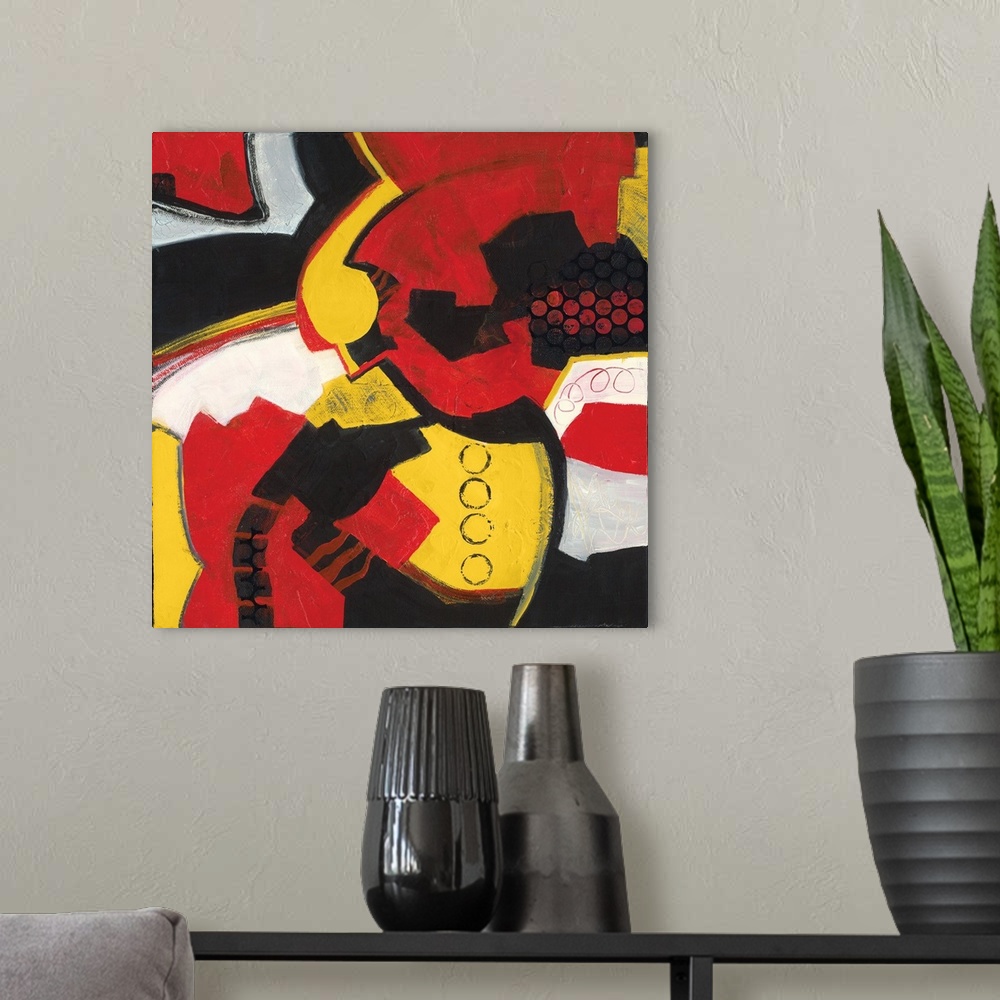 A modern room featuring Square abstract painting with bold red, yellow, black, and white hues.