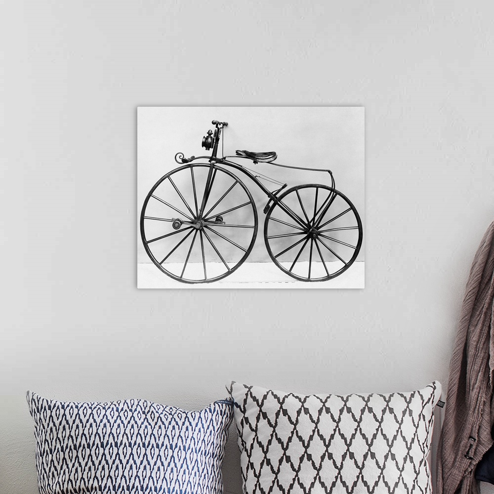 A bohemian room featuring An early bicycle, known as a bone shaker.