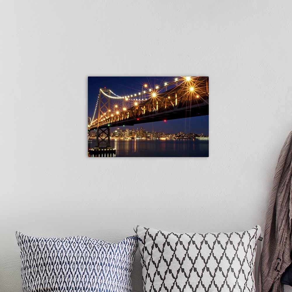 A bohemian room featuring A burst of lights on the Bay Bridge and San Francisco skyline in the background.