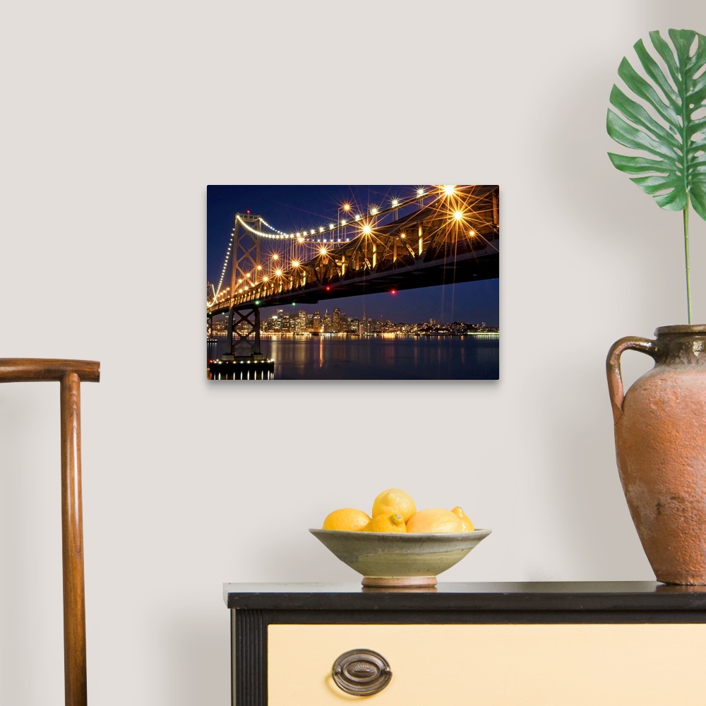 A traditional room featuring A burst of lights on the Bay Bridge and San Francisco skyline in the background.