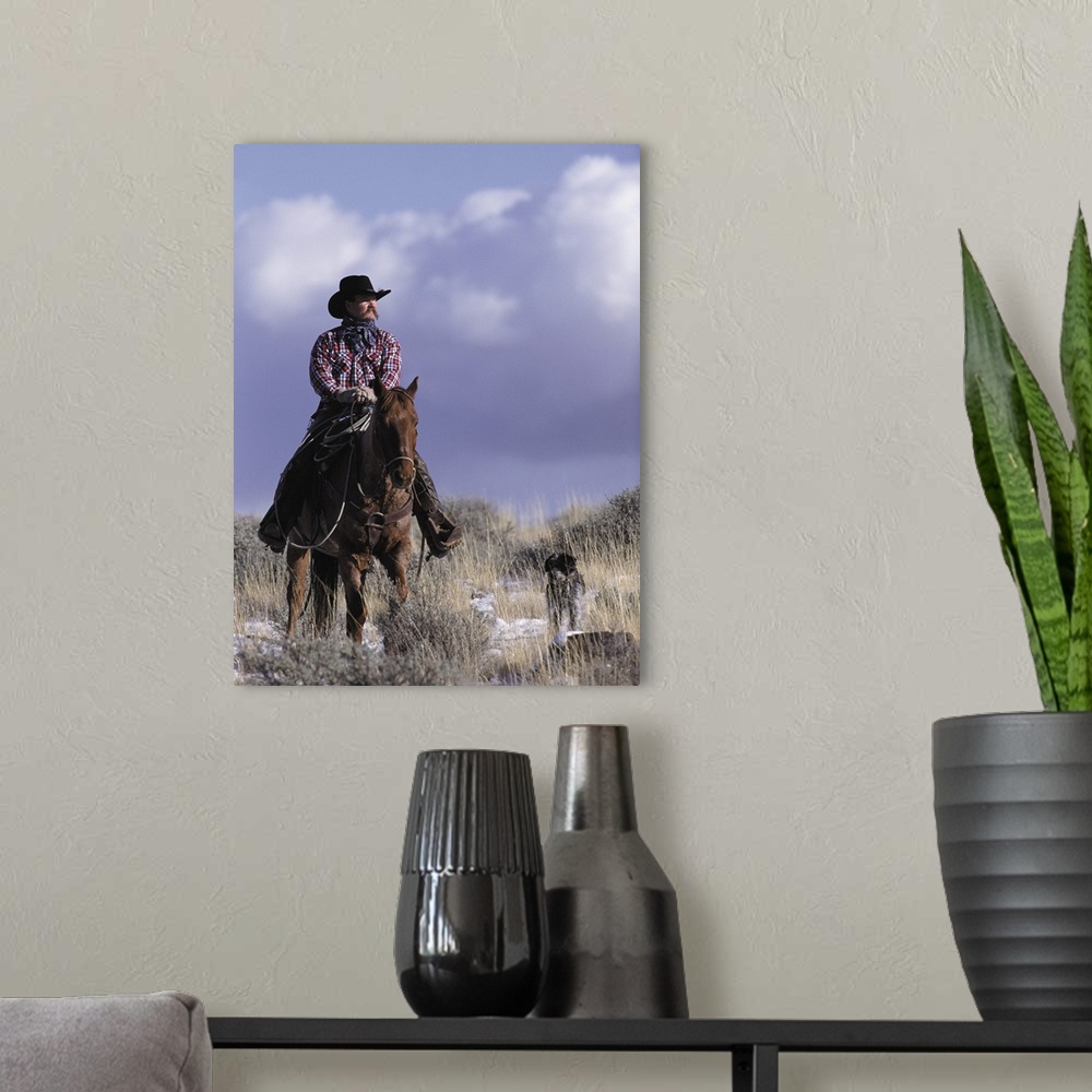 A modern room featuring A cowboy poses on his horse with his dog