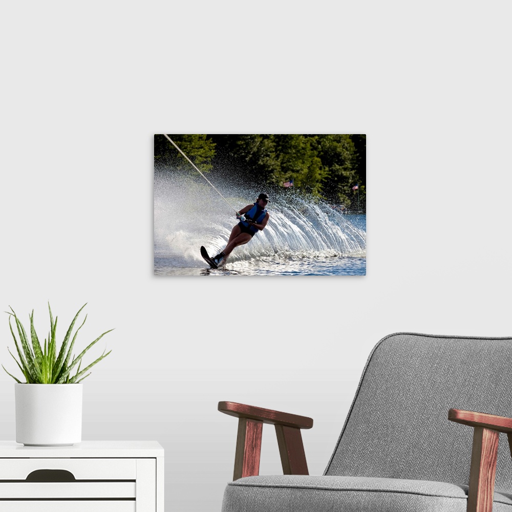 A modern room featuring A female water skier rips a turn causing a huge water spray while skiing on Cobbosseecontee Lake ...