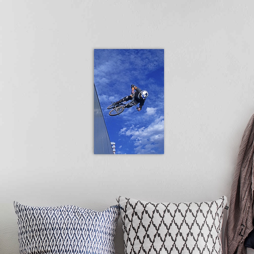 A bohemian room featuring A free skier jumps over a rocky and ice covered mountain.