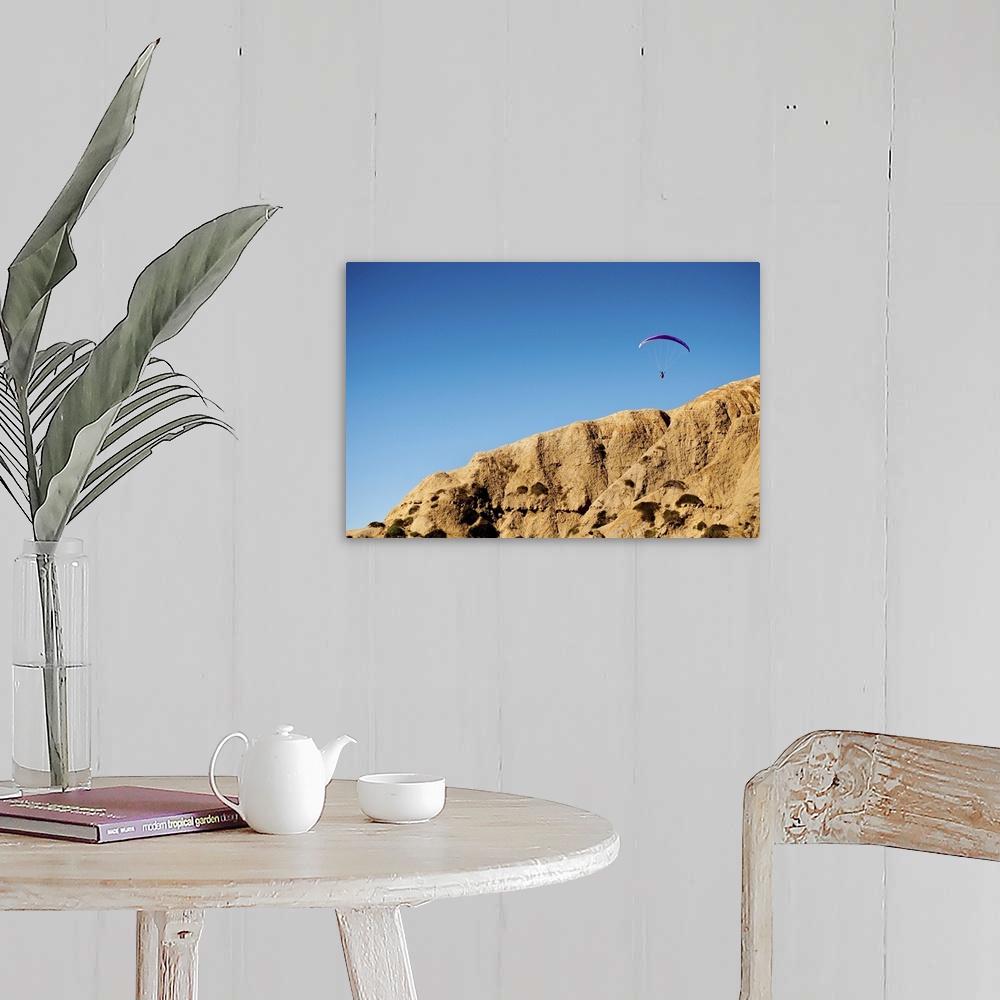 A farmhouse room featuring A hang glider floats above the cliffs of Torrey Pines over La Jolla, California.