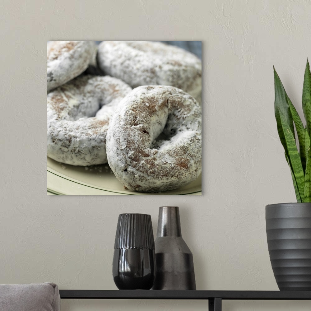 A modern room featuring A plate of sugar donuts aka 'doughnuts'
