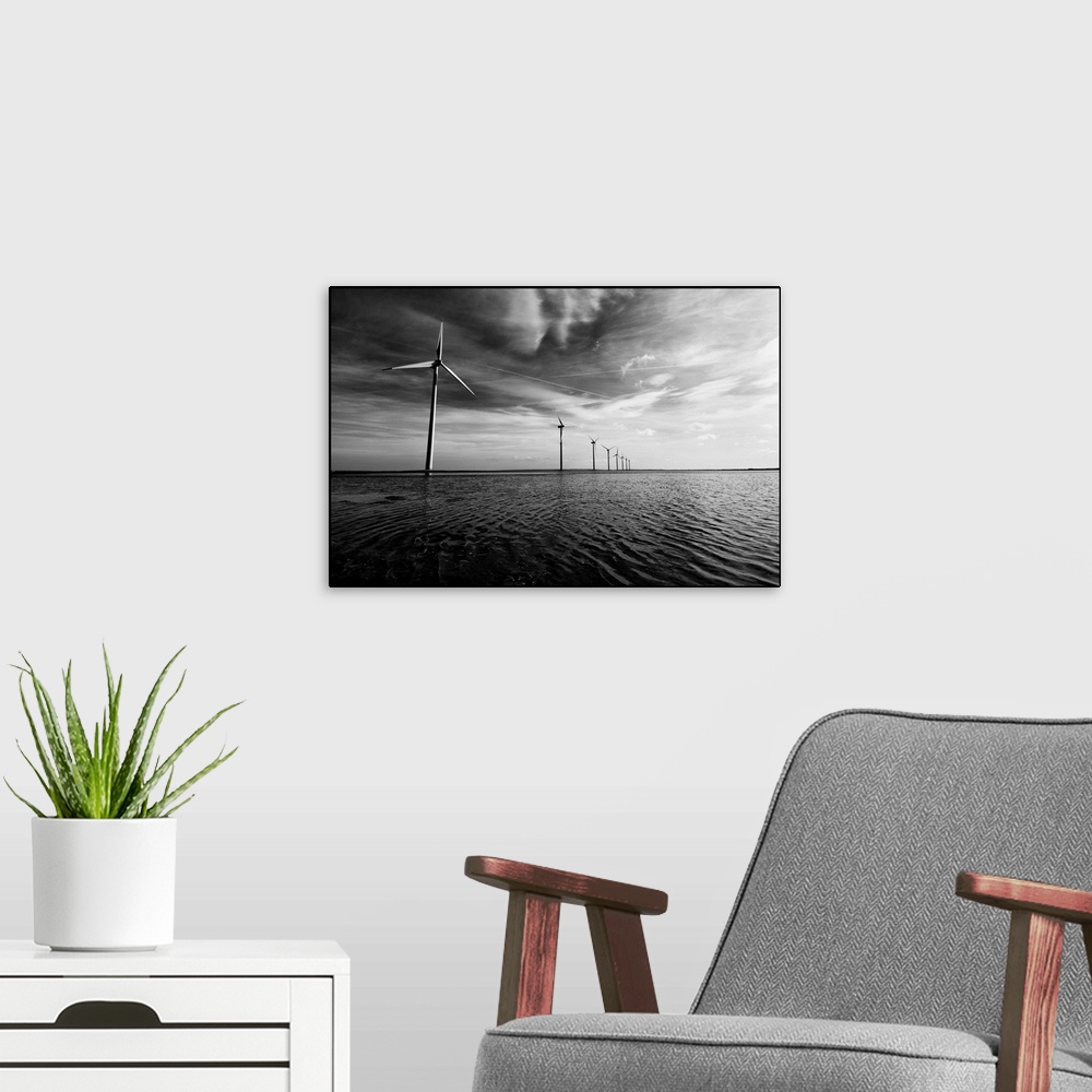 A modern room featuring A row of windmills in the sea, in the water with a dramatic sky and dramatic clouds overhead.Blac...