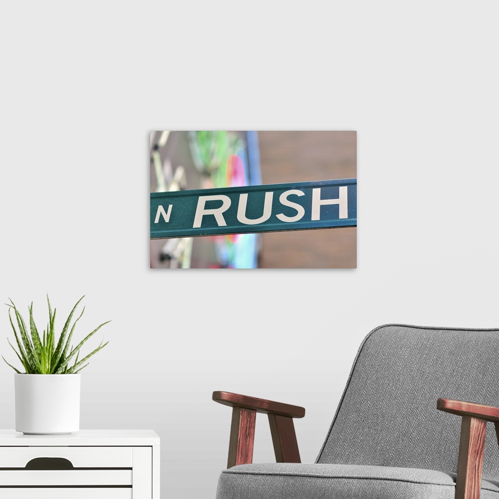 A modern room featuring A Rush Street  sign in front of a neon sign representing the glitter of the well-known Chicago en...