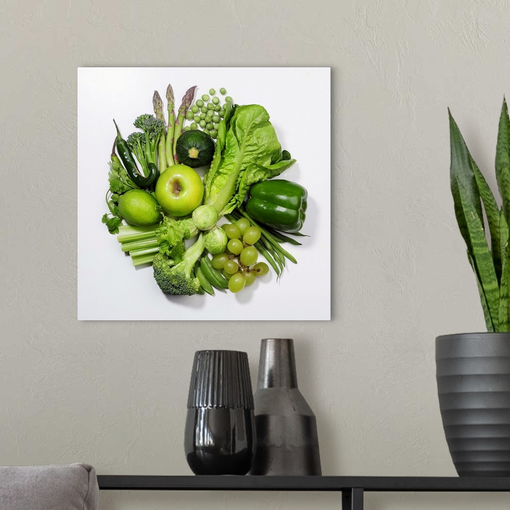 A modern room featuring A selection of green fruits & vegetables.