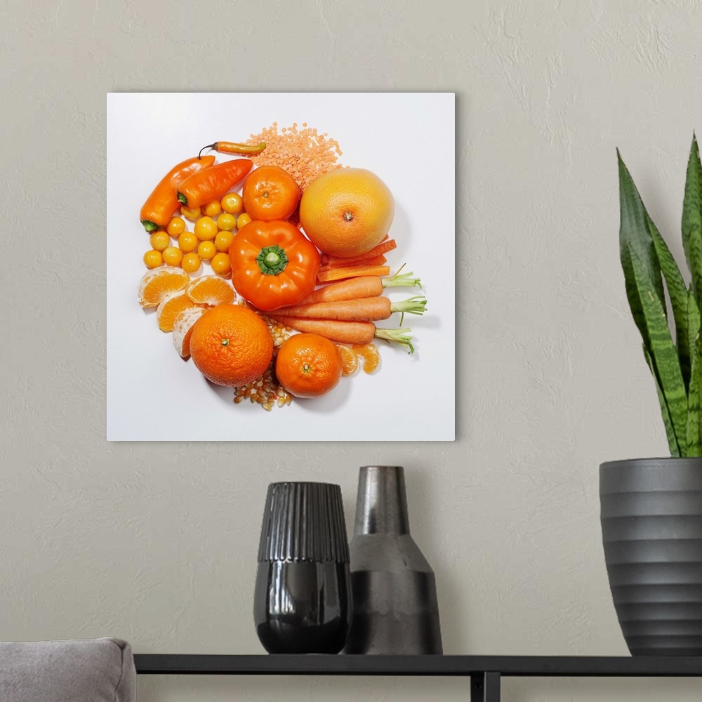 A modern room featuring A selection of orange fruits & vegetables.