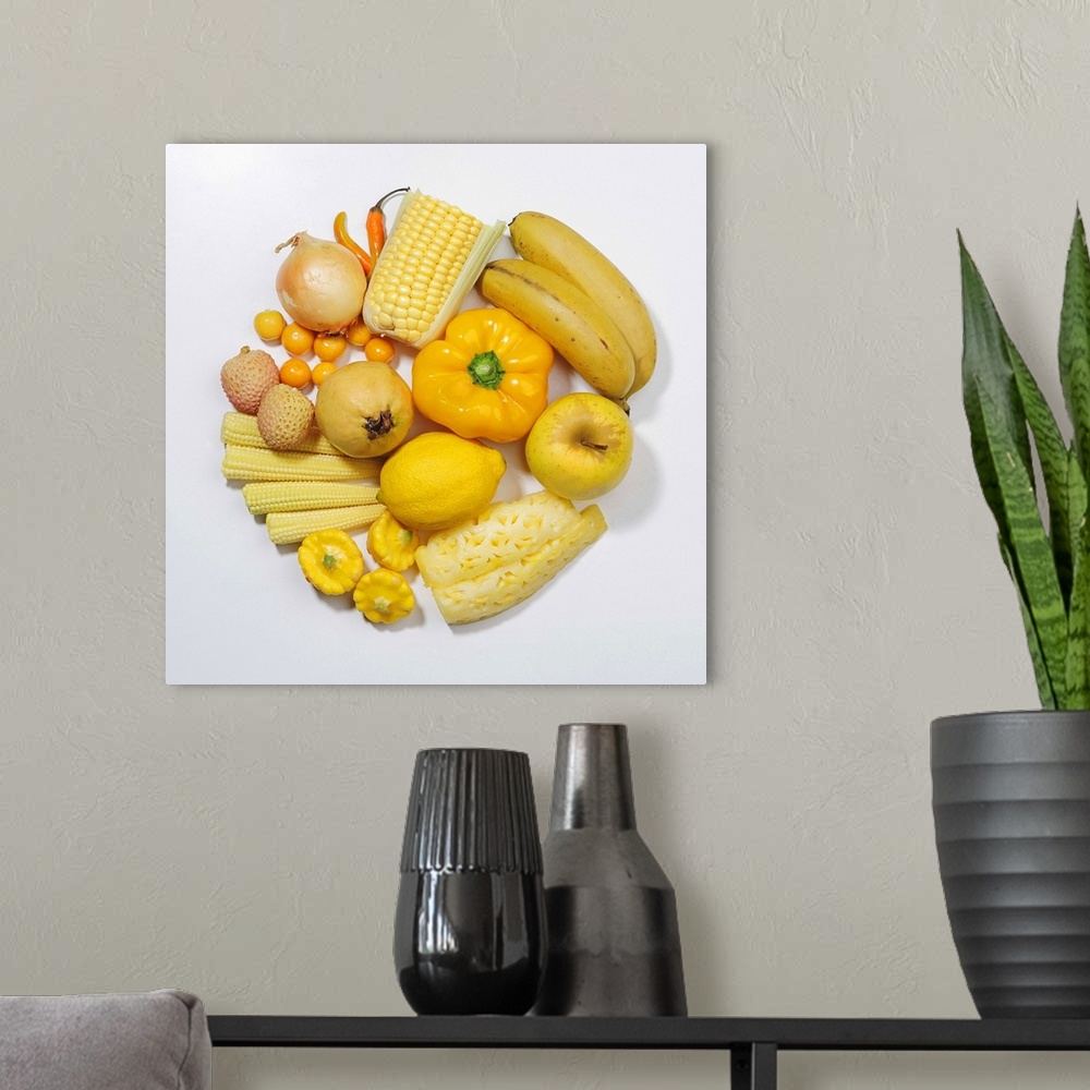 A modern room featuring A selection of yellow fruits & vegetables.