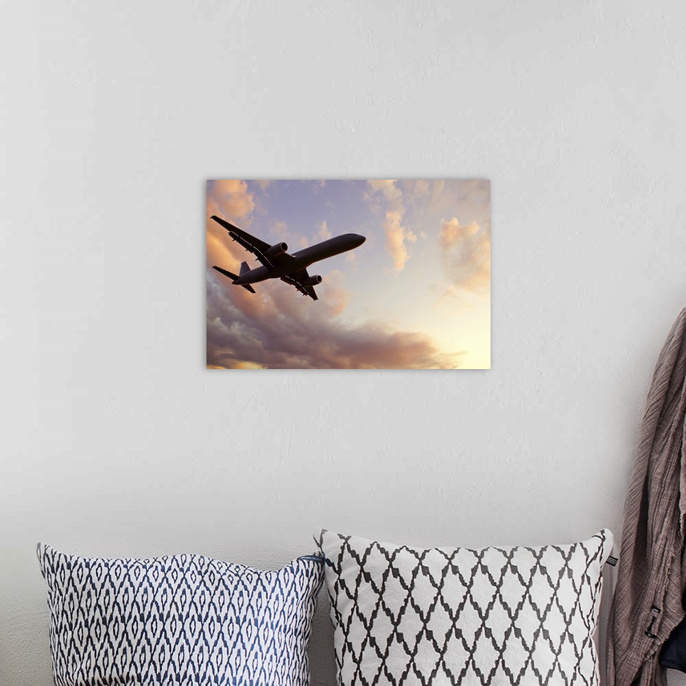 A bohemian room featuring A silhouetted airplane flies among a few clouds