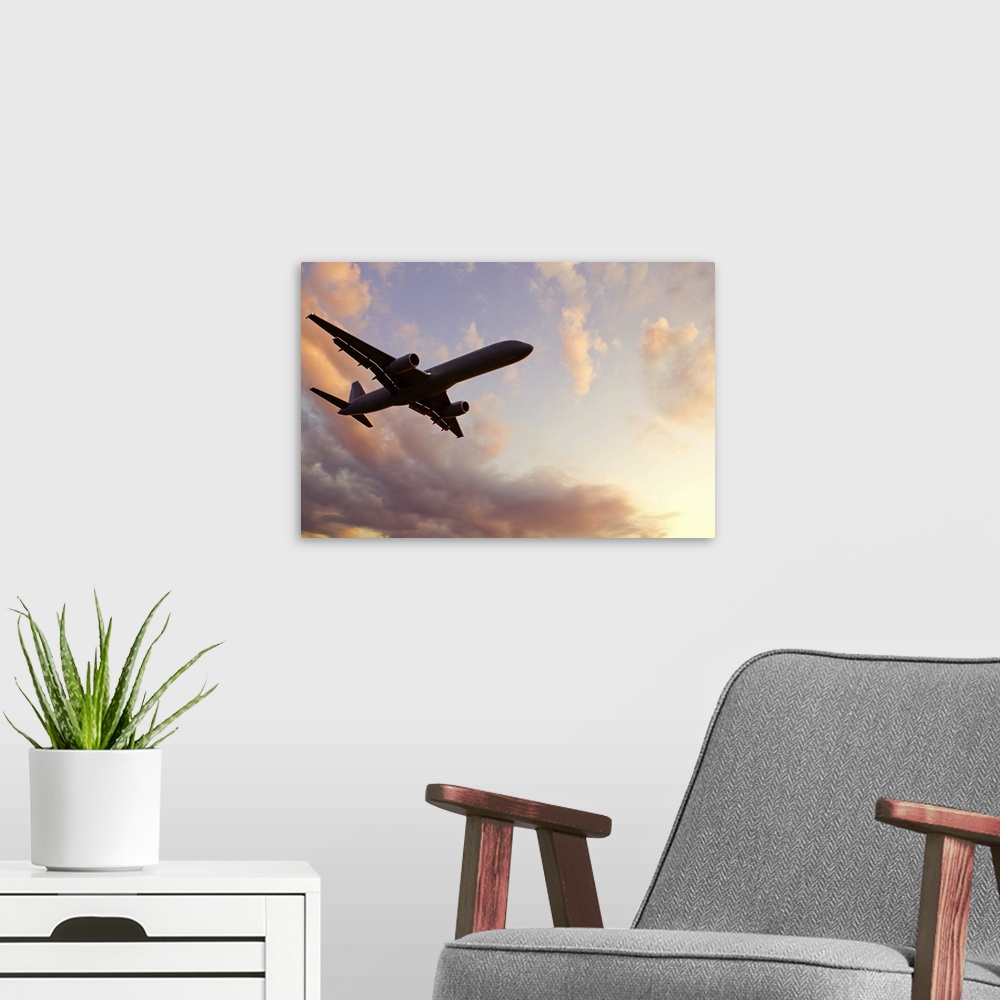 A modern room featuring A silhouetted airplane flies among a few clouds