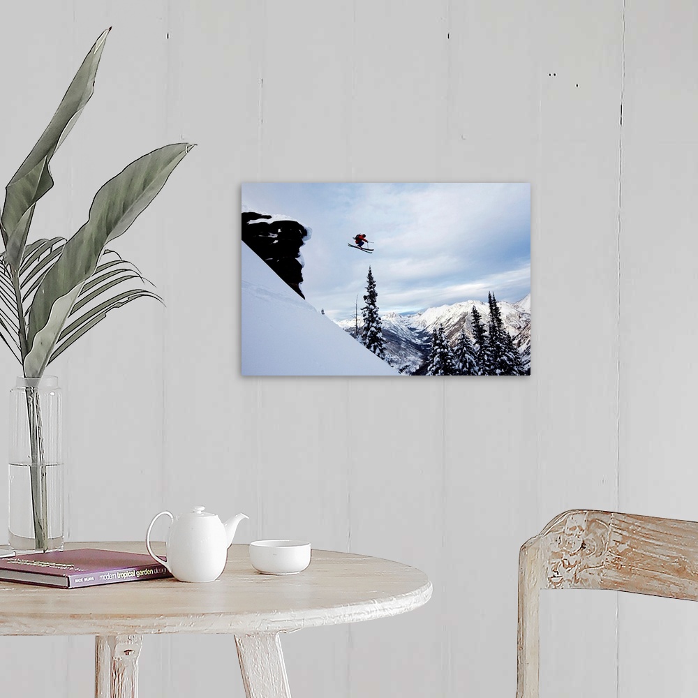 A farmhouse room featuring A athletic skier jumping off a cliff in the backcountry in Colorado.