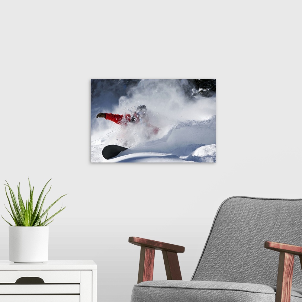 A modern room featuring A snowboarder sending snow flying as they ride down the slopes in Colorado.