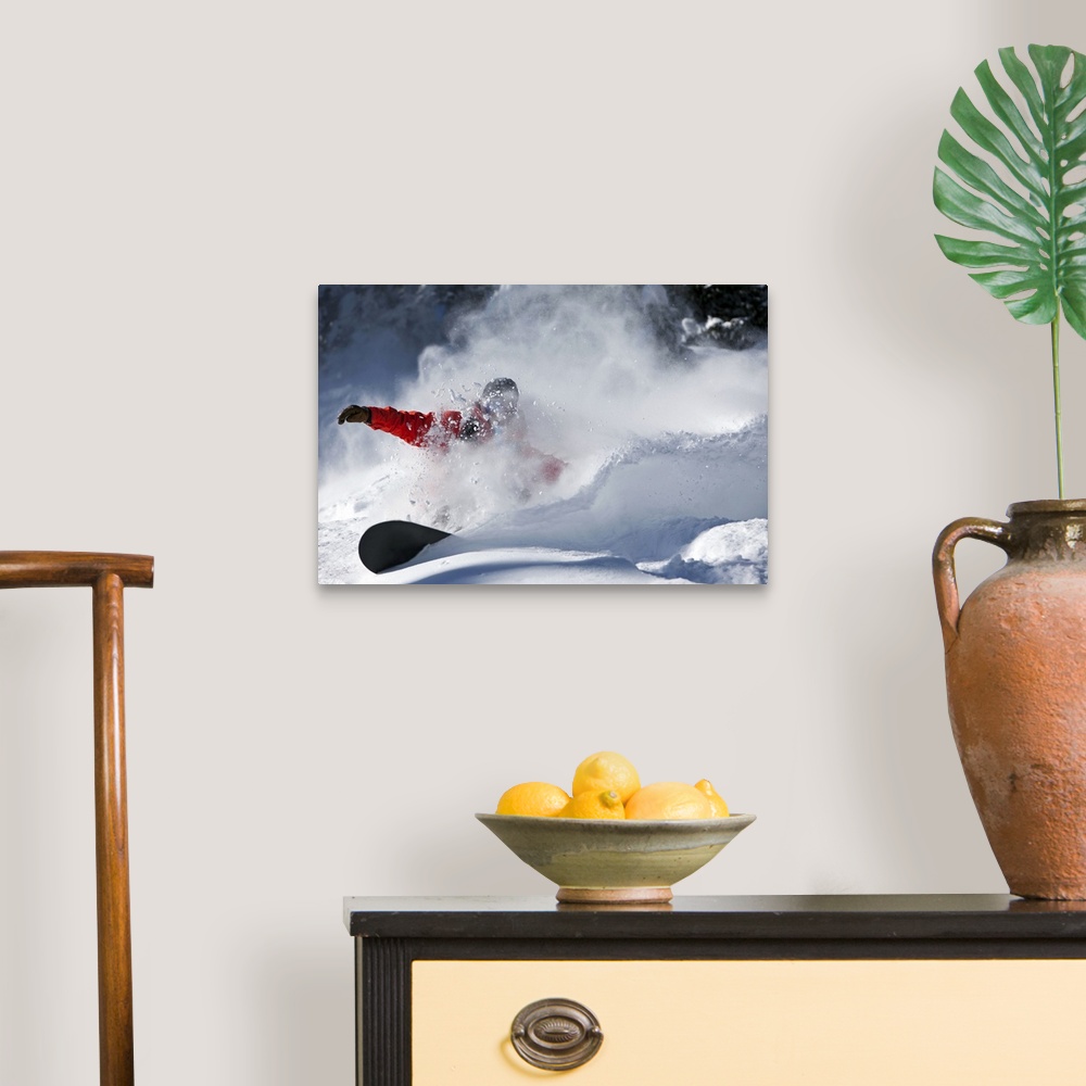 A traditional room featuring A snowboarder sending snow flying as they ride down the slopes in Colorado.