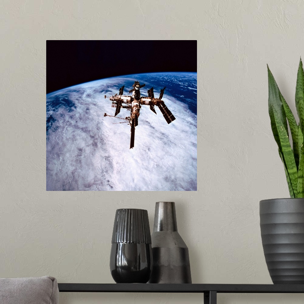 A modern room featuring A space station in orbit above the earth