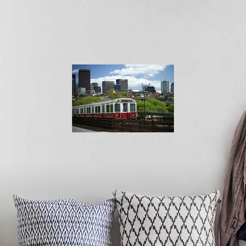 A bohemian room featuring A train with Boston skyline background