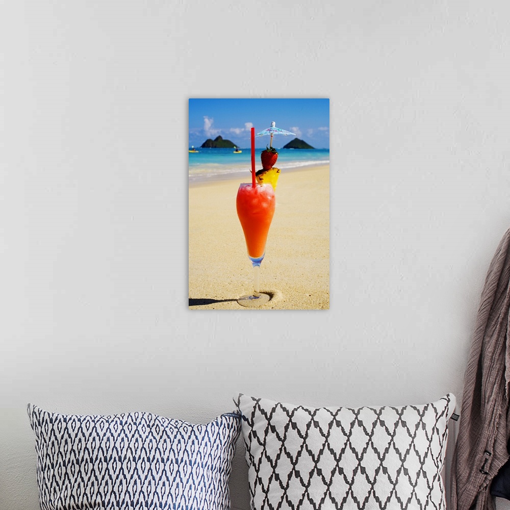 A bohemian room featuring A tropical cocktail on the beach, Mokulua Islands and kayakers in background.