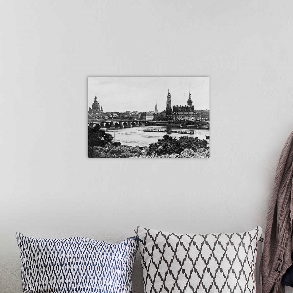 A bohemian room featuring A view of the old Bridge and the surrounding buildings across the Elbe River in Dresden.