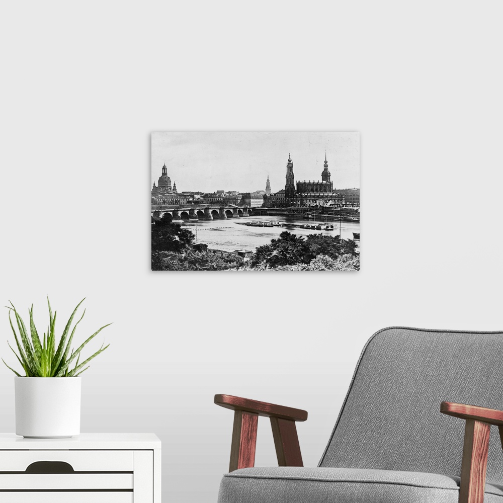 A modern room featuring A view of the old Bridge and the surrounding buildings across the Elbe River in Dresden.