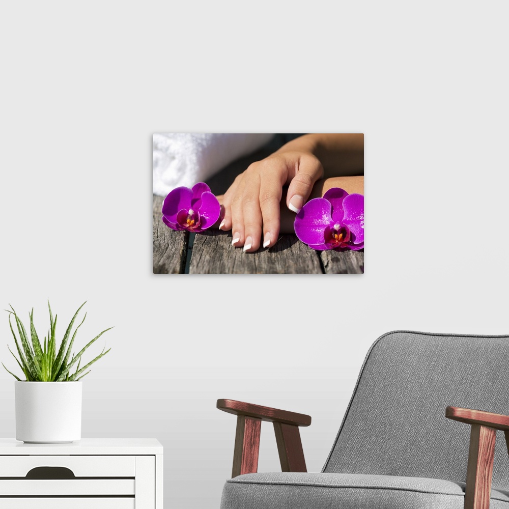 A modern room featuring Close up of womans nails and orchids