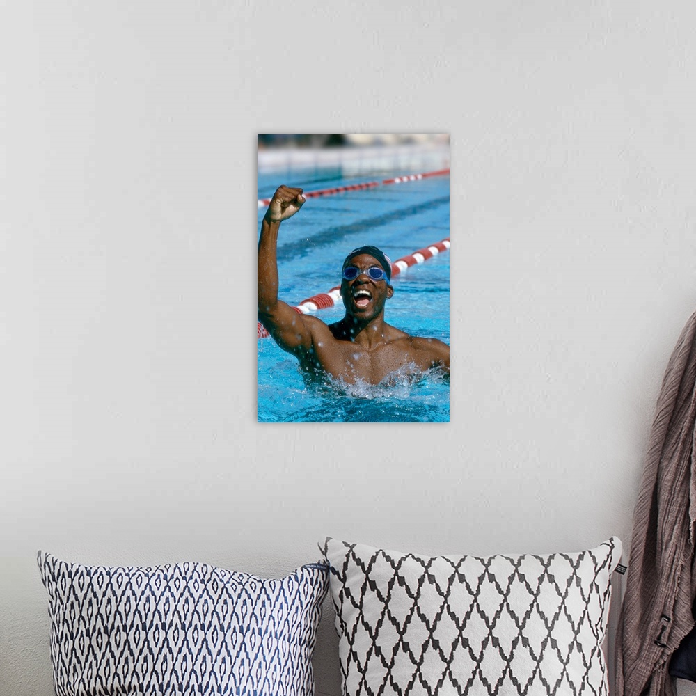 A bohemian room featuring portrait of a young male swimmer raising his hands in victory