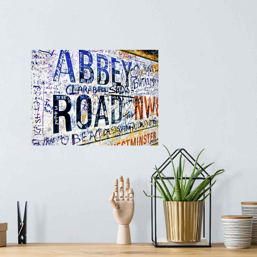 A bohemian room featuring Famous Abbey Road road sign covered with grafitti from Beatle fans