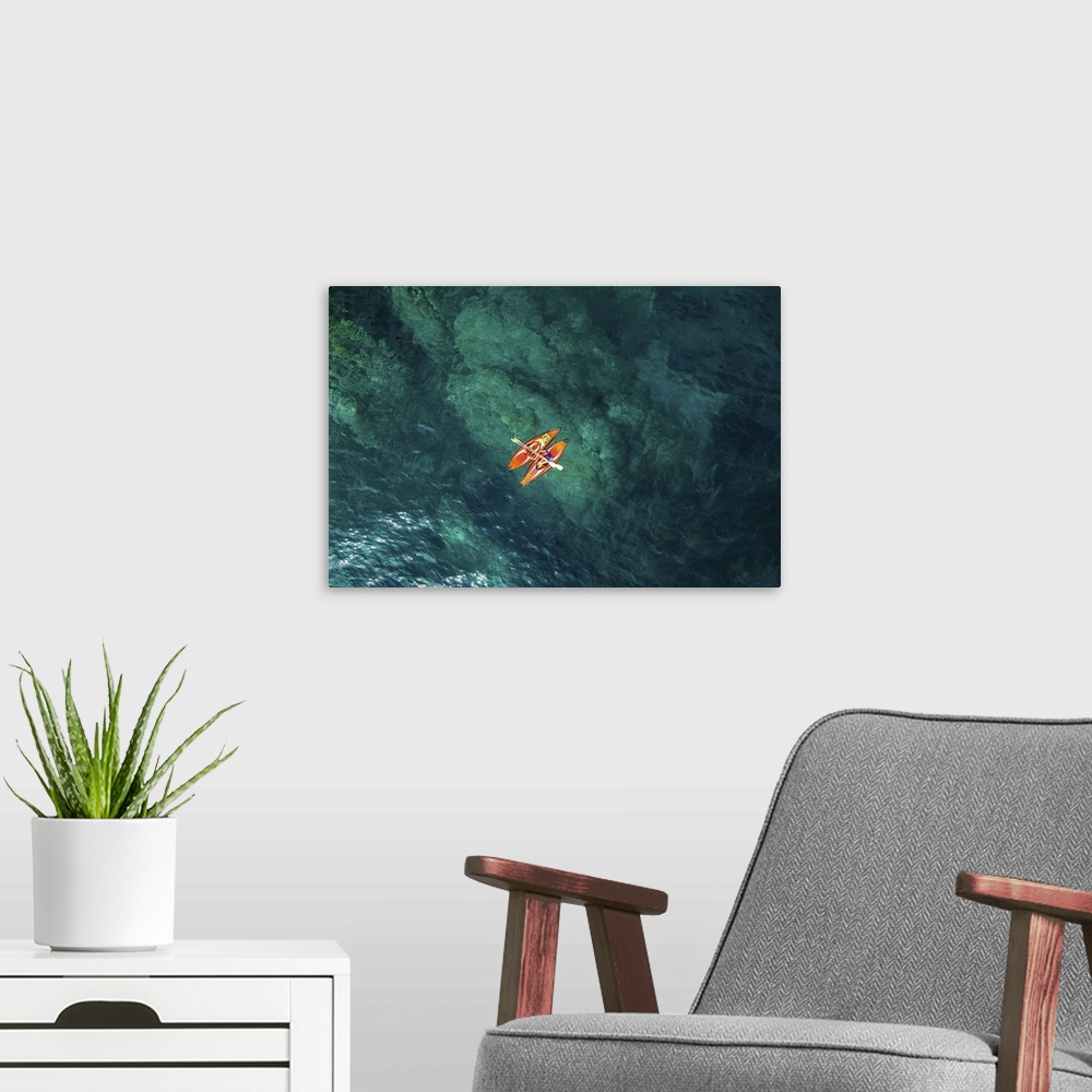 A modern room featuring Aerial picture of two girls practicing kayak in a paradise place of the costa brava beach with be...