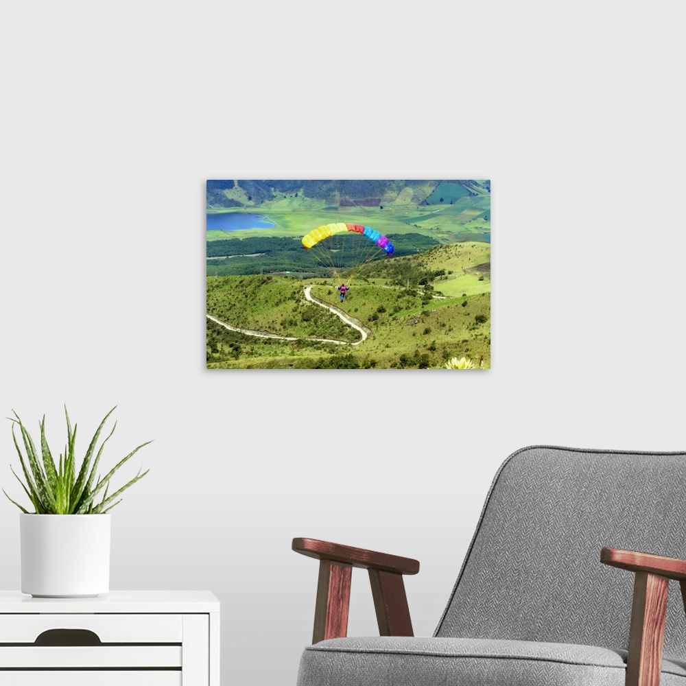 A modern room featuring Aerial view of a person paragliding