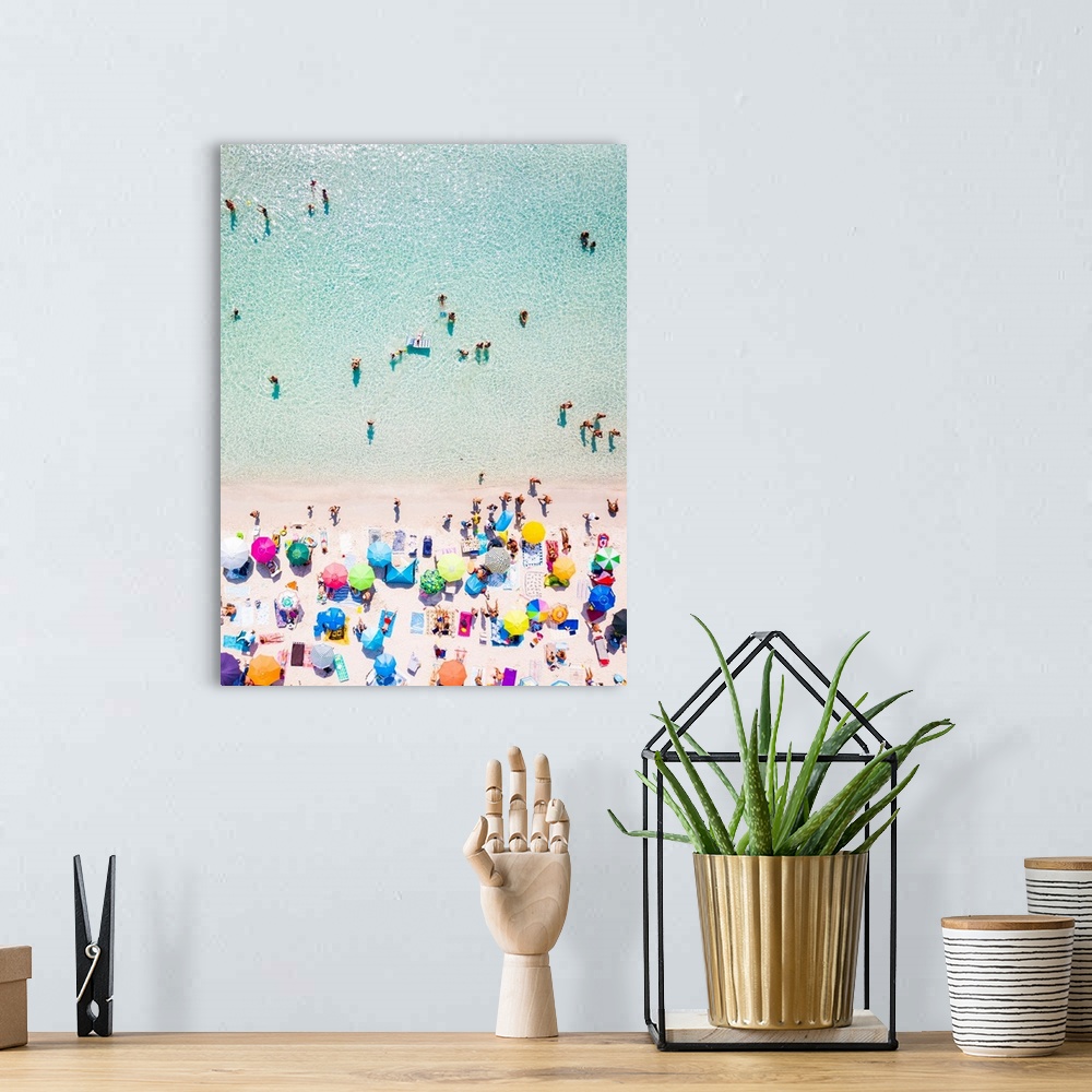 A bohemian room featuring Aerial view of a white beach full of colored beach umbrellas and relaxed people swimming on a cle...