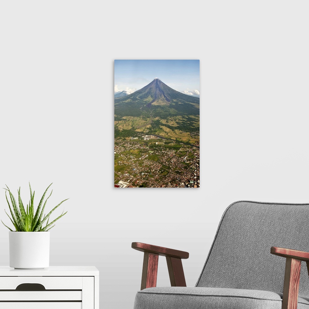 A modern room featuring Aerial view of mayon Volcano and Cityscape of Legazpi at morning in Philippines.