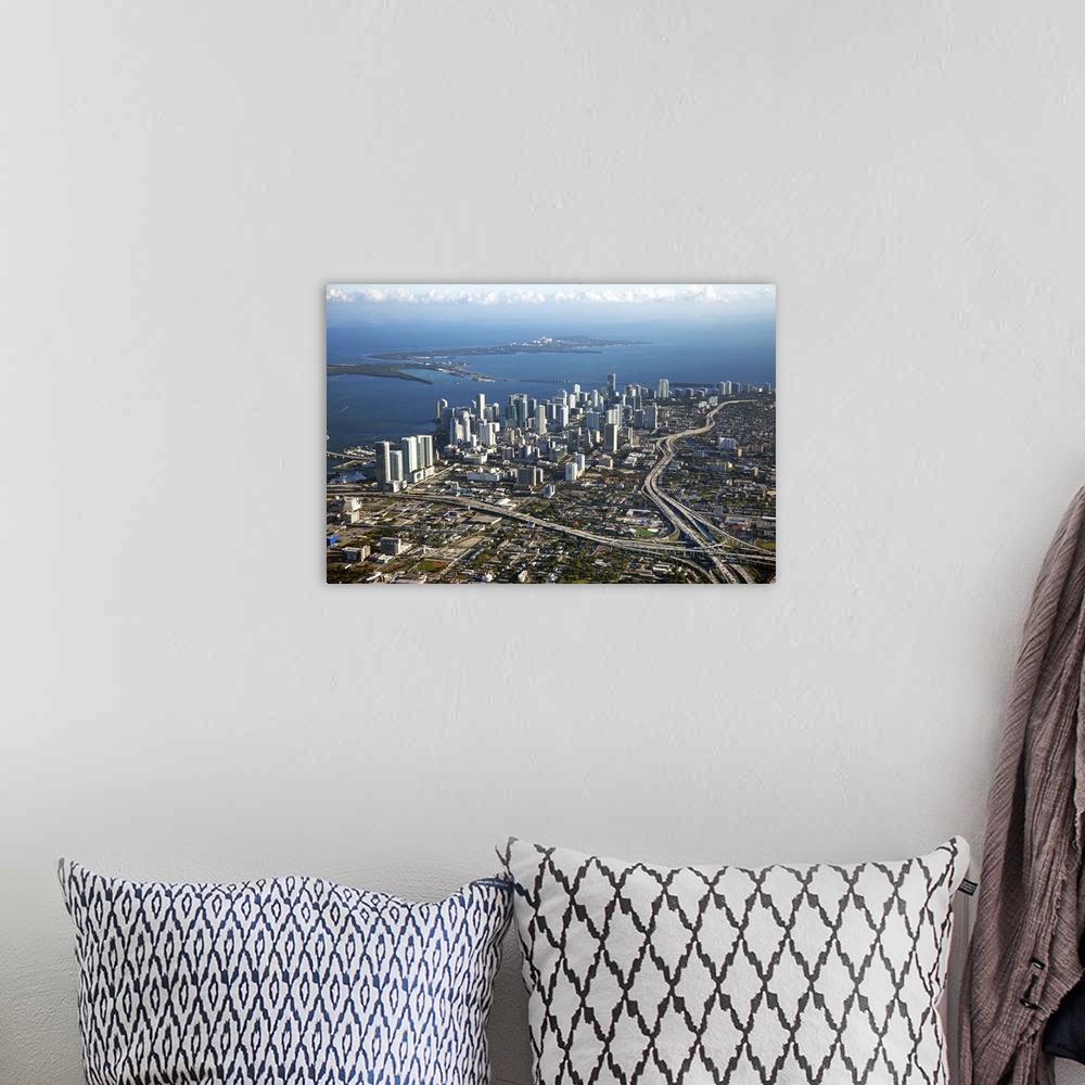 A bohemian room featuring Photograph taken from above the city of Miami with the skyscrapers to the left and near the water...