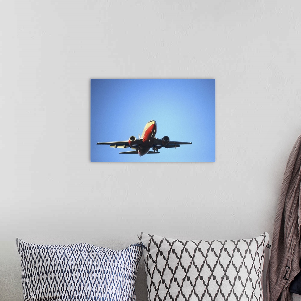 A bohemian room featuring Aeroplane flying across blue sky