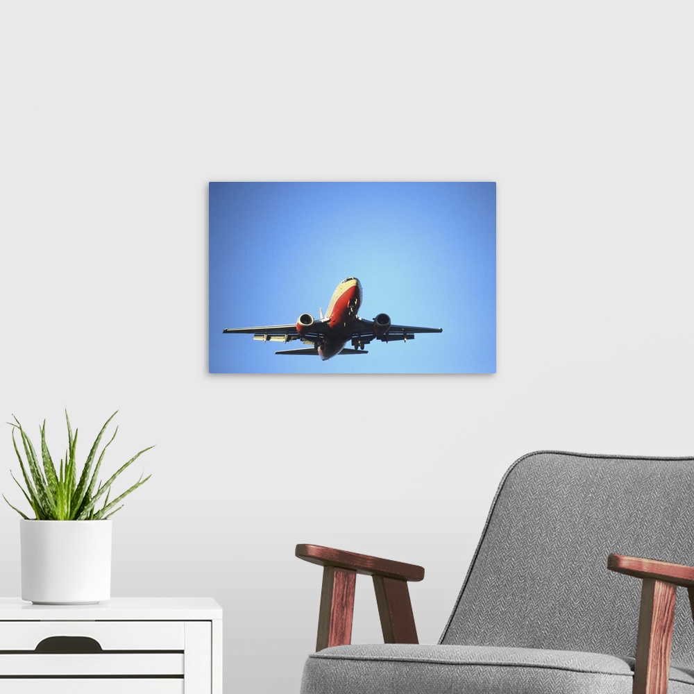 A modern room featuring Aeroplane flying across blue sky