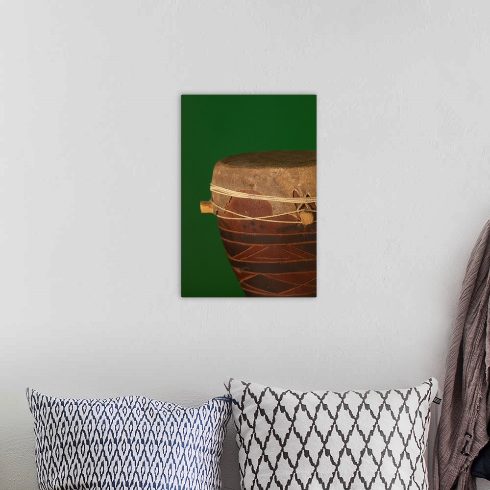 A bohemian room featuring African drum on green backgound