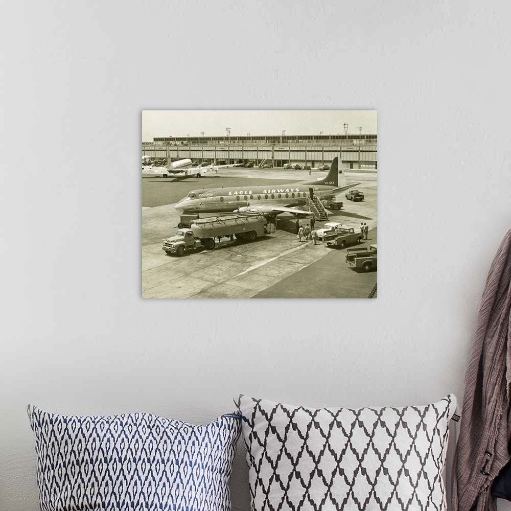 A bohemian room featuring Airplane getting refuelled on airport runway, (B&W), (Elevated view)