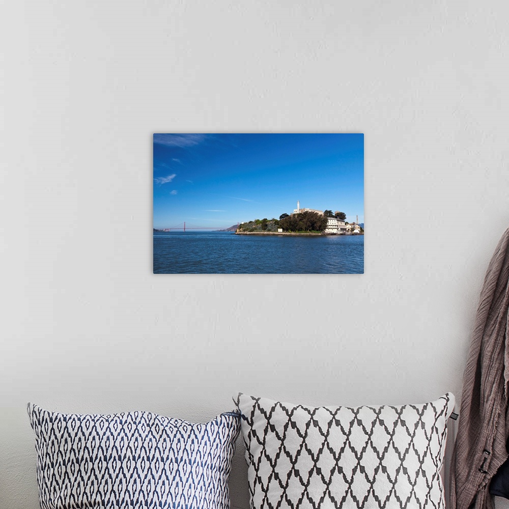 A bohemian room featuring Alcatraz island and rock and Golden Gate bridge on bright and sunny day.