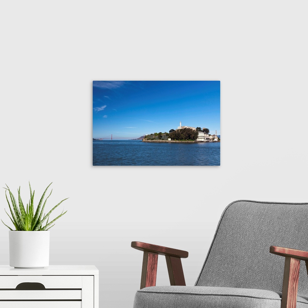 A modern room featuring Alcatraz island and rock and Golden Gate bridge on bright and sunny day.