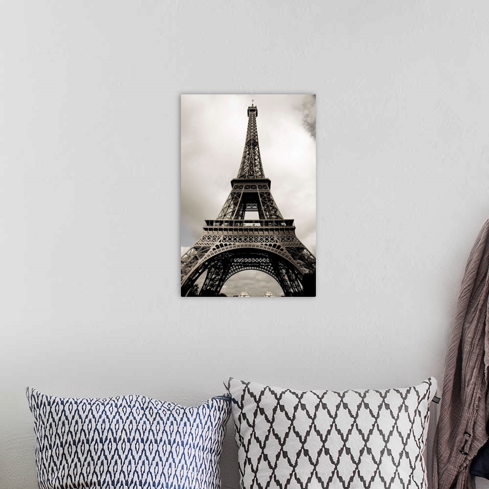 A bohemian room featuring Black and white photograph taken vertically looking up at the Eiffel Tower.