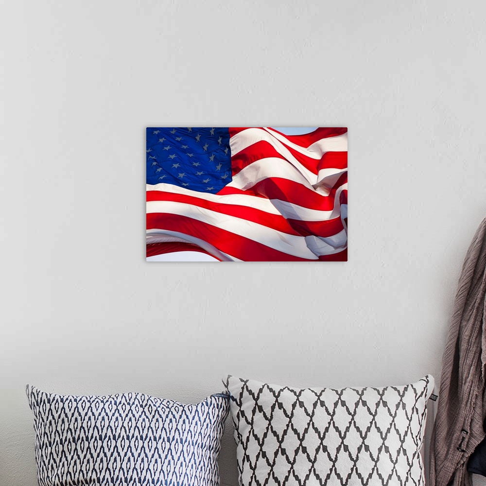 A bohemian room featuring USA, Washington, Cashmere, Backlit view of large American flag flying outside roadside candy stan...