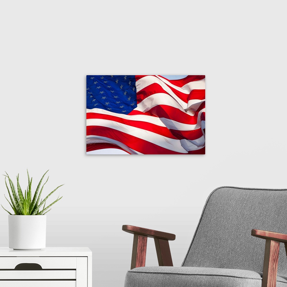 A modern room featuring USA, Washington, Cashmere, Backlit view of large American flag flying outside roadside candy stan...