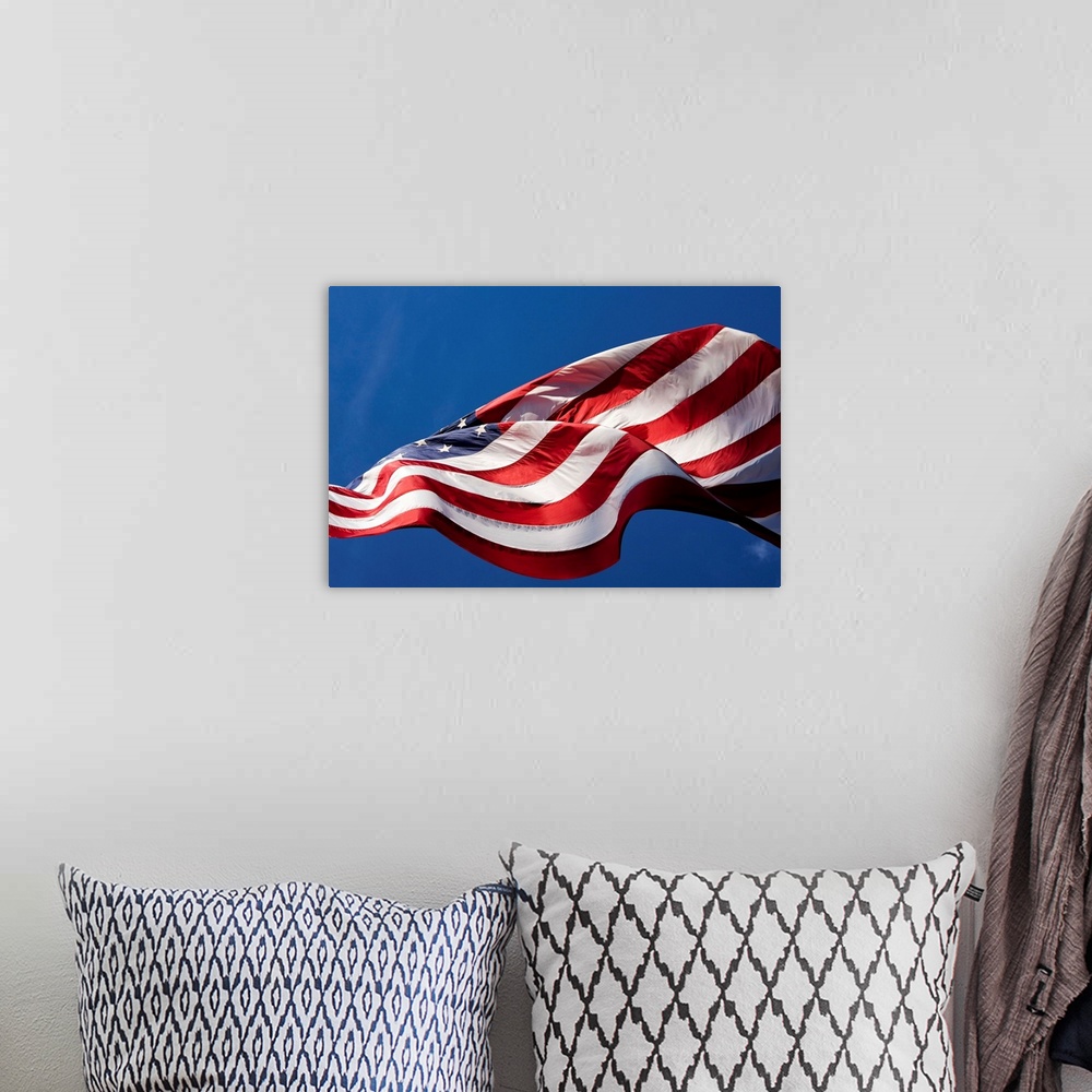 A bohemian room featuring USA, Washington, Cashmere, View from below large American flag flying outside roadside candy stan...